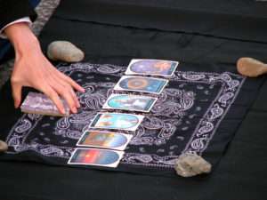 Accurate Tarot Reading Reviews Tarot Reader Laying a Spread on a Black Handkerchief with Stones at Each Corner